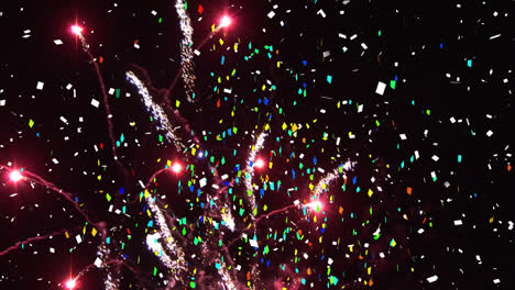 Animation-of-confetti-and-fireworks-exploding-on-black-background