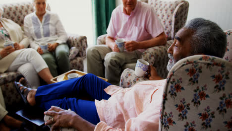 Side-view-of-active-African-american-senior-man-interacting-with-senior-friends-in-the-nursing-home-