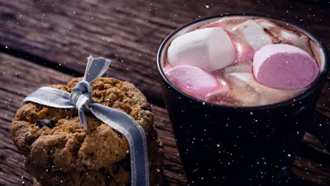 Falling-snow-with-Christmas-hot-chocolate-and-cookie