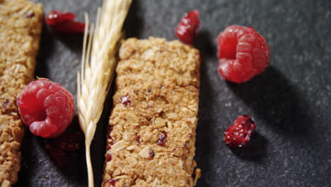 Granola-bars-with-barley-and-raspberry-on-concrete-background-4k