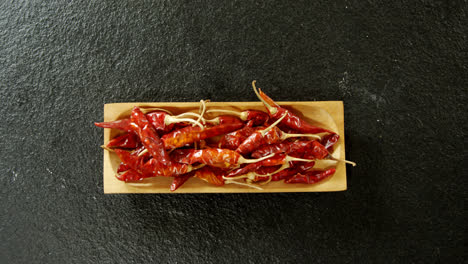 Dried-chili-pepper-in-wooden-tray-4k