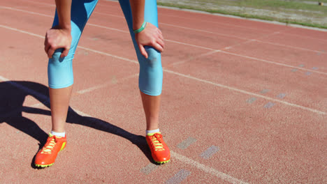 Low-section-of-female-athlete-standing-on-running-track-4k