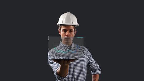 Caucasian-male-worker-with-a-hard-hat-holding-a-tablet-displaying-a-screen-with-statistics