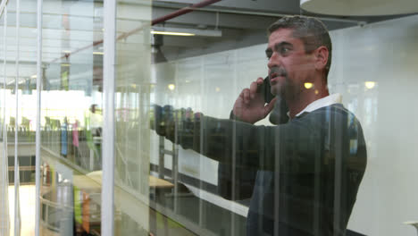 Businessman-talking-on-mobile-phone-in-modern-office-4k