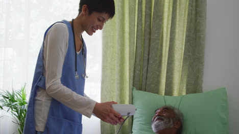 Nurse-helping-a-senior-man-in-retirement-house