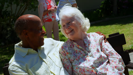 Front-view-of-active-mixed-race-senior-couple-smiling-and-looking-at-each-other-in-the-garden-of-nur