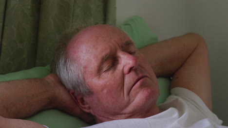 Senior-man-in-social-distancing-sleeping-in-retirement-house