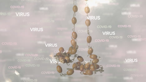 Covid-19-and-virus-text-against-rosary-falling