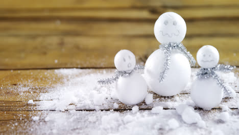 Handmade-snowman-on-wooden-table-4k