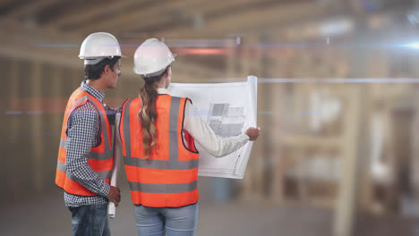 Two-Caucasian-workers-wearing-an-orange-high-vest-and-hat-checking-their-plan-and-pointing-fingers