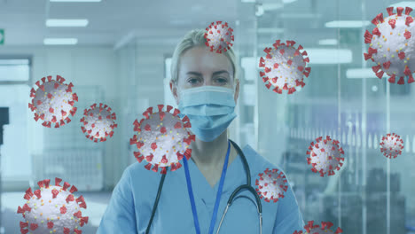 Animation-of-covid-19-cells-floating-with-woman-putting-face-mask-on