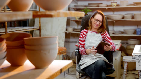 Female-potter-using-digital-tablet-4k