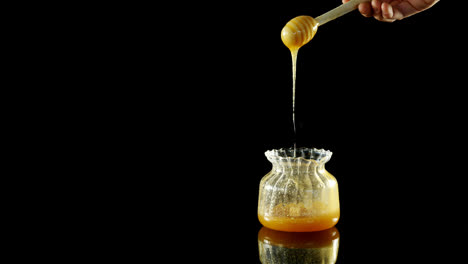 Honey-being-poured-into-a-jar-4k