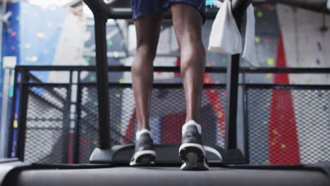 Low-section-of-fit-african-american-man-running-on-treadmill-in-the-gym