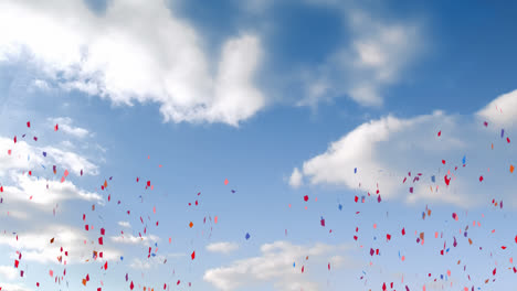 Animation-of-multi-coloured-confetti-falling-over-blue-sky-and-clouds