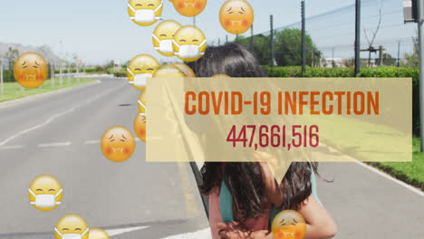 Animation-of-covid-19-infection-numbers-and-emojis-with-masked-schoolchild-crossing-road