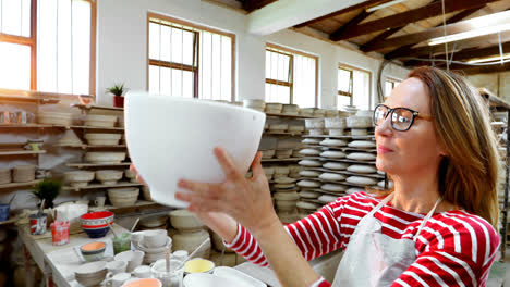 Female-potter-checking-bowl-4k