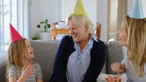 Family-celebrating-birthday-on-sofa-4k
