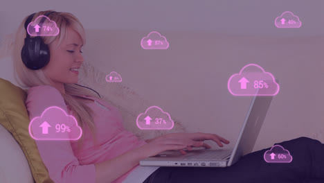 Animation-of-pink-clouds-with-percent-going-to-one-hundred-over-female-student-using-laptop-computer