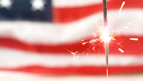 Independence-day-text-and-a-flag-behind-a-sparkle-for-fourth-of-July.