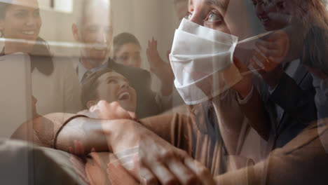 Woman-in-face-mask-against-office-colleagues-celebrating-together