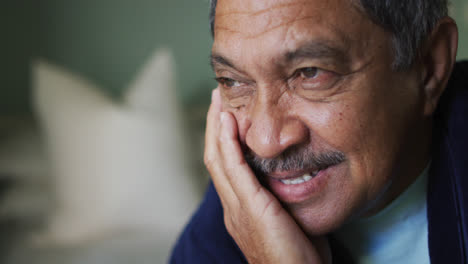 Portrait-of-senior-mixed-race-man-looking-away-smiling
