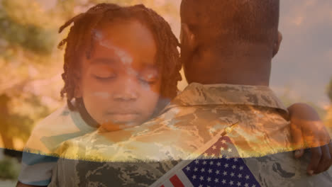 Military-man-in-uniform-carrying-a-child-holding-an-American-flag