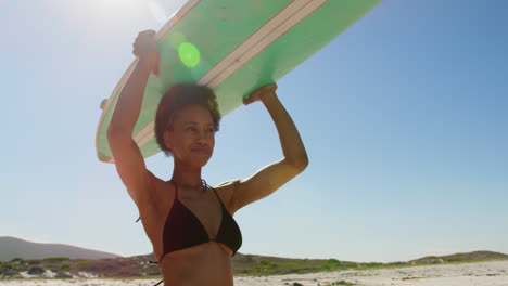Female-surfer-carrying-surfboard-on-her-head-4k