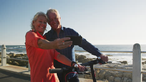 Senior-couple-taking-picture-alongside-beach