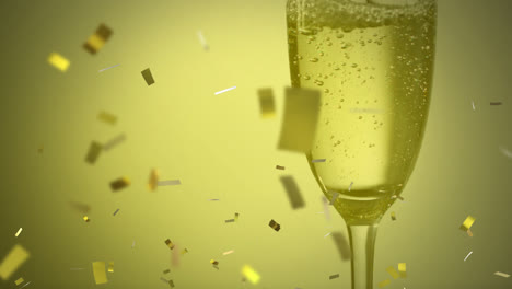 Animation-Von-Goldenem-Konfetti,-Das-Auf-Ein-Champagnerglas-Fällt
