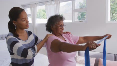 Senior-mixed-race-woman-exercising-at-home.-Social-distancing-and-self-isolation-in-quarantine