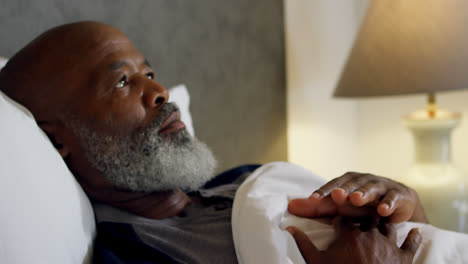 Senior-man-relaxing-in-bedroom-at-home-4k