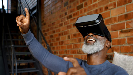 Senior-man-using-virtual-reality-headset-in-living-room-4k