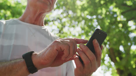 Senior-man-using-smartphone-in-the-park