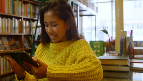 Teenage-girl-using-digital-tablet-in-library-4k