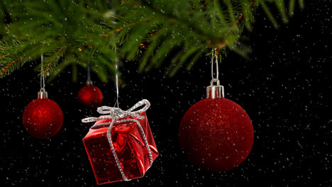 Animation-of-red-christmas-baubles-decoration-with-snow-falling