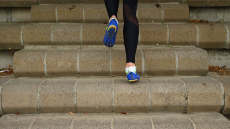 Low-section-of-female-athlete-exercising-on-steps-at-sports-venue-4k