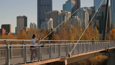 Side-view-of-young-Caucasian-man-having-coffee-on-the-bridge-in-the-city-4k