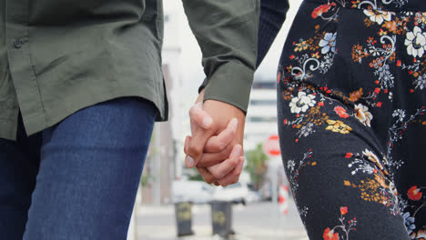 Couple-holding-hand-while-walking-on-street-4k