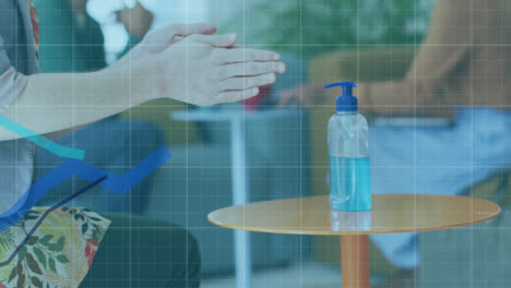 Animation-of-digital-interface-showing-statistics-with-woman-disinfecting-hands-in-office