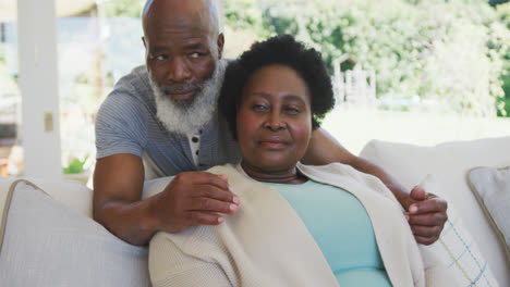 Happy-senior-african-american-couple-embracing-and-smiling