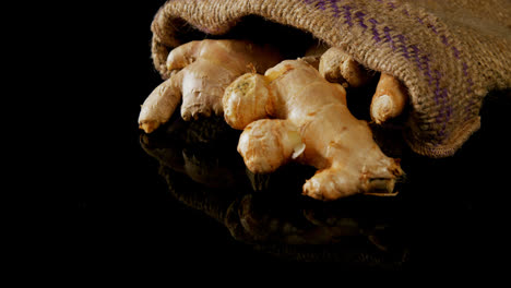Ginger-spilling-out-from-the-sack-on-black-background-4k