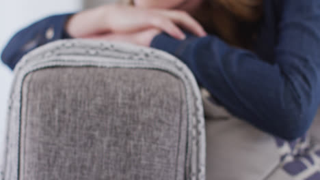 Close-up-view-of-woman-lying-on-the-couch-at-home