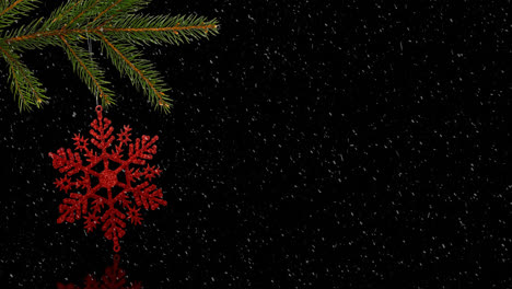 Animation-of-red-christmas-decoration-on-tree-with-snow-falling