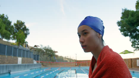 Female-swimmer-sitting-near-swimming-pool-4k