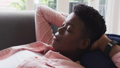 Close-up-of-african-american-woman-sleeping-on-the-couch-at-home