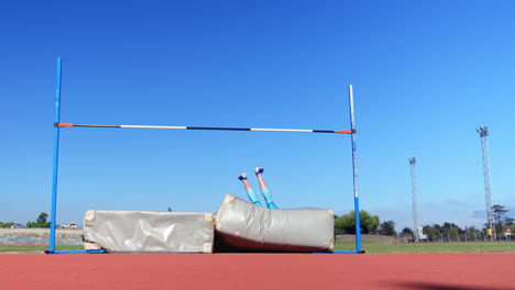 Caucasian-female-athlete-practicing-high-jump-at-sports-venue-4k