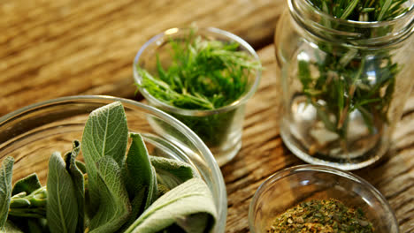Various-herbs-in-a-jar-on-wooden-table-4k