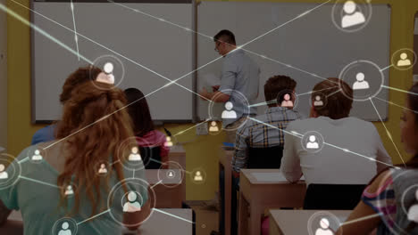 Animation-of-network-of-connections-over-students-sitting-in-a-classroom-their-teacher-by-the-whiteb