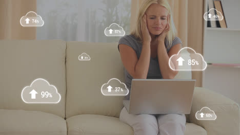 Animation-of-white-clouds-with-percent-going-to-one-hundred-over-female-student-using-laptop-compute